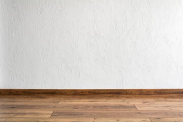 Empty room with white wall and parquet. Minimal interior design.