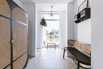 Stylish retro furniture in elegant bright corridor of trendy home