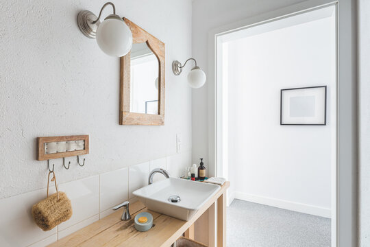 Stylish Ceramic Sink On Trendy Wooden Console Table In Small Elegant Bathroom