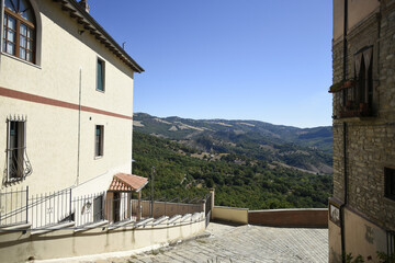 A narrow street among the old houses of Guardia Perticara, a rural village in the Basilicata region, Italy.