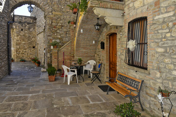 A narrow street among the old houses of Guardia Perticara, a rural village in the Basilicata region, Italy.