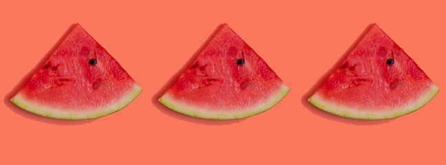 Creative flat top view of fresh watermelon slices on a pink background. Banner.