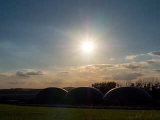 Fototapeta na wymiar Biogasanlage in Deutschland bei Sonnenuntergang