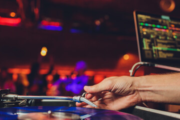 DJ playing vinyl musical record at hip hop party,festival.Concert in the nightclub.Professional...