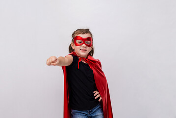 a little girl in a superhero costume on a white isolated background