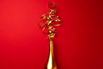 Champagne bottle with streamers flat lay top view