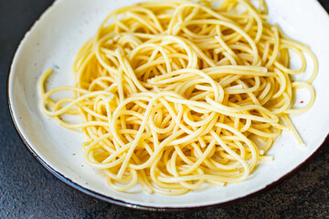 spaghetti pasta plate macaroni semola durum wheat on the table serving portion size top view place copy space for text