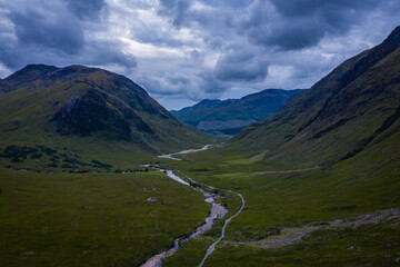 aerial panorama image of glen etive in the argyll region of the highlands of scotland during a dark stormy evening in summer