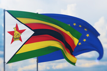 Waving European Union flag and flag of Zimbabwe. Closeup view, 3D illustration.