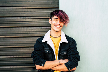 Cheerful portrait of caucasian young man teenager smiling at the camera - two colors background gray and white - urban people style having fun in outdoor - Powered by Adobe