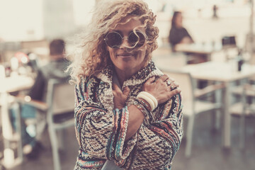 Autumn people trendy lifestyle concept - portrait of beautiful people smile and hug for the cold temperature outdoor with trendy accessories