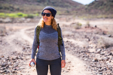 Beautiful adult woman stand up and enjoy the outdoor trekking leisure activity - healthy lifestyle...