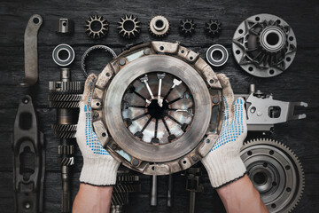 Old car clutch basket in auto service worker hands close up. - obrazy, fototapety, plakaty