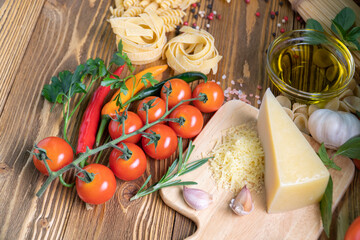Pasta collection on rustic wooden. top view Various types of Italian raw food. pasta spaghetti with tomatoes and Olive oil, spice rustic background. 