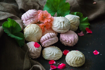 Delicious pink marshmallows on a marble table. Sweets.