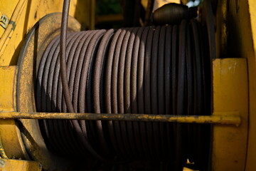 Fototapeta na wymiar Dirty steel cable winch on and excavator. Close up. 