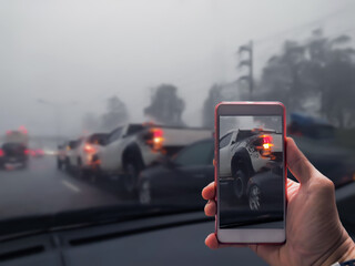 Close Up Of A Hand Taking Photo Of Car Accident Through Smartphone, Car crash from car accident on...