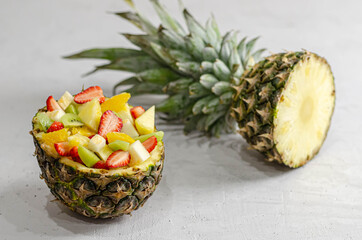 fruit salad in pineapple with different fruits.