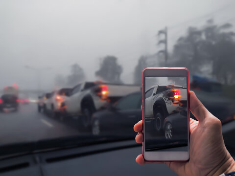 Close Up Of A Hand Taking Photo Of Car Accident Through Smartphone, Car Crash From Car Accident On The Road In A City Car Pickup Wait Insurance Smartphone Call A Car Insurance.