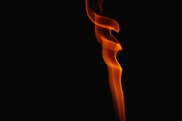 Orange smoke on a black background. Colored smoke. Smoke illuminated by orange light. Bizarre spellbinding flames.