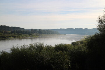 Fototapeta na wymiar View of the misty river from the morning in summer