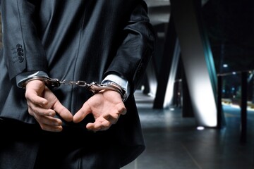 Fototapeta premium Criminal man with his hands in handcuffs