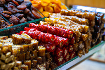 Various bright colored turkish delights sweets baklava lokum and dried fruits vegetables on market in Istanbul, Turkey