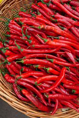 harvest of red chili peppers in a wicker basket