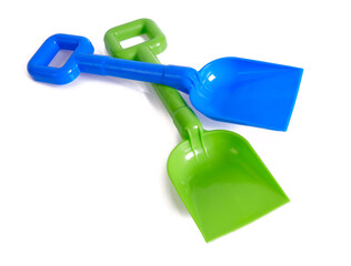 green and blue plastic shovels isolated on white