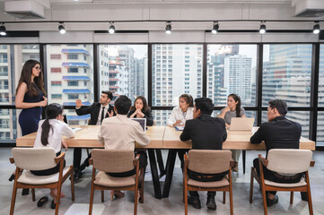 Multi ethnic business colleague seriously meeting and discussing on conference table in modern office