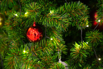 Decorated Christmas tree on blurred, sparkling and fairy background with color ball