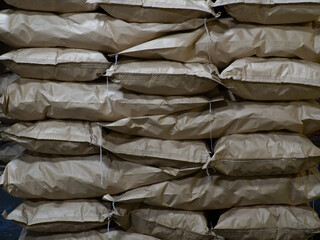 Fototapeta na wymiar Full brown kraft paper bags with charcoal, at a coal plant, bags texture