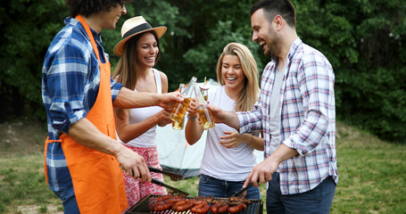 Fototapeta premium Friends having a barbecue party in nature