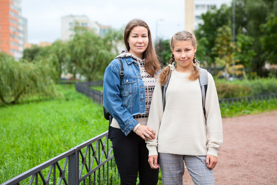 Mother And Her Middle School Age Daughter With Backpack On Back, Student In Grade 6 Goes Back To School At September