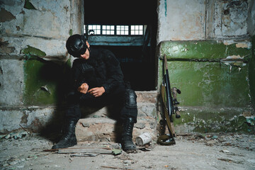 Portrait of special forces soldier reloading his pistol.