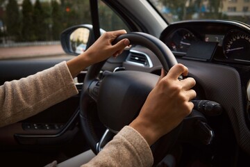 Women's hands on the wheel. Cars interior