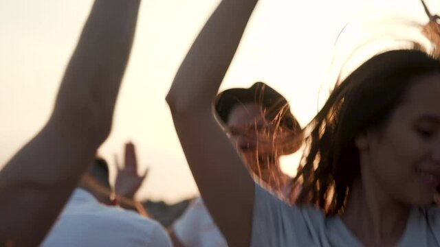 Happy Laughter Trendy Female Listen Music and Dance in Summer Sunshine. Multi Ethnic Group Young Girls and Guys Arms Raised Enjoy Nature Outdoor. Extravagant People Energy Playing Slow Motion Close Up