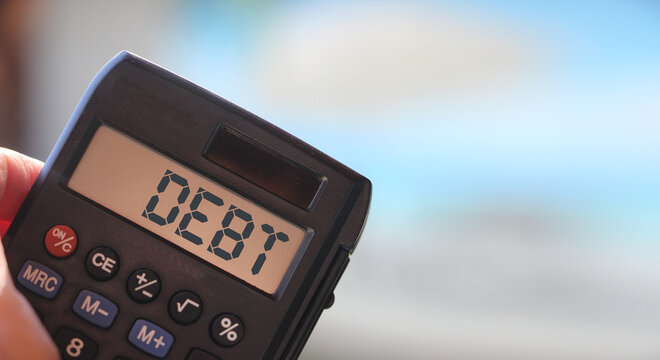 debt word on calculator display. Financial obligations business crisis concept