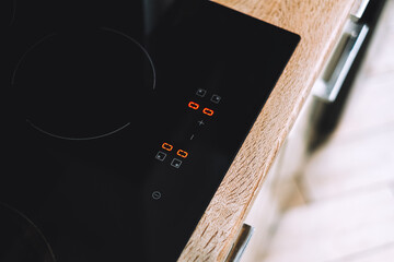 Black electric stove for cooking in the kitchen, close-up. Modern kitchen detail.