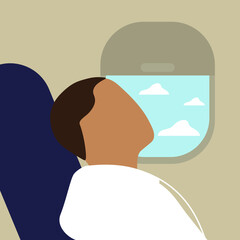 A man sits on an airplane and looks out the window