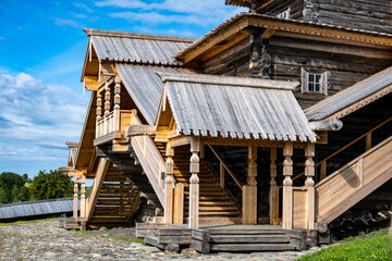 vintage wooden complex with temple watchtower and fortress wall against blue sky