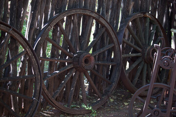 Fototapeta na wymiar Old Wagon Wheel against a fence