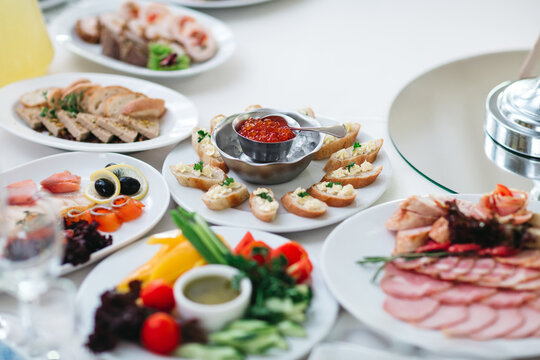 Close up of delicious dishes, salads and appetizers on served celebration table. Michelin restaurant. Luxury all inclusive menu. Traditional wedding recipe. Concept of main course and gourmet cuisine.