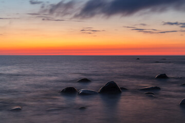 Naklejka na ściany i meble Rocky shore and peninsula of Baltic sea at sunset. Nordic minimalistic wilderness.