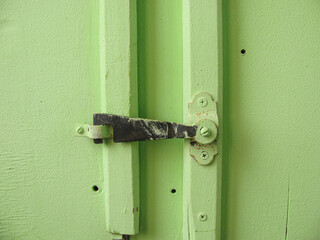 sliding lock, latch on the doors of the green Cabinet