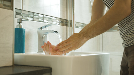 Washing hands intensively close up in a modern bathroom