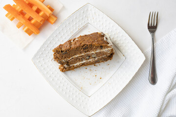 Slice of carrot cake and coffee on white background