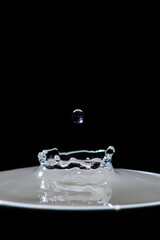 Drop of water on a crown of water that is formed by dropping a drop on a well of water