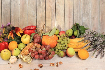 Autumn composition with seasonal pears, pumpkins, apples and flowers on a wooden background, Happy Thanksgiving concept, postcard, selective focus.