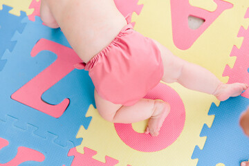 Baby on bright mat